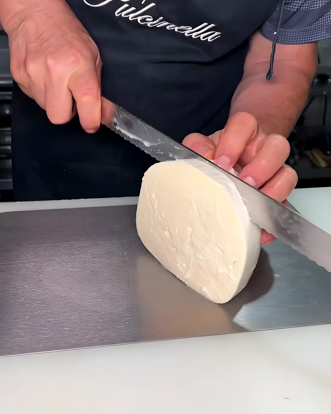 Mozzarella cortada a cuchillo sobre la mesada